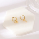 <div id="offer-template-0">These 18K gold plated stainless steel earrings are the cutest addition to your jewelry collection. These earrings have detachable charms that you can interchange with other SOCALI charms. Cute angel wing detailing on the lock and key.&nbsp;</div> <div></div> <div> <p>Material: 18K Gold Plated Stainless Steel</p> </div>