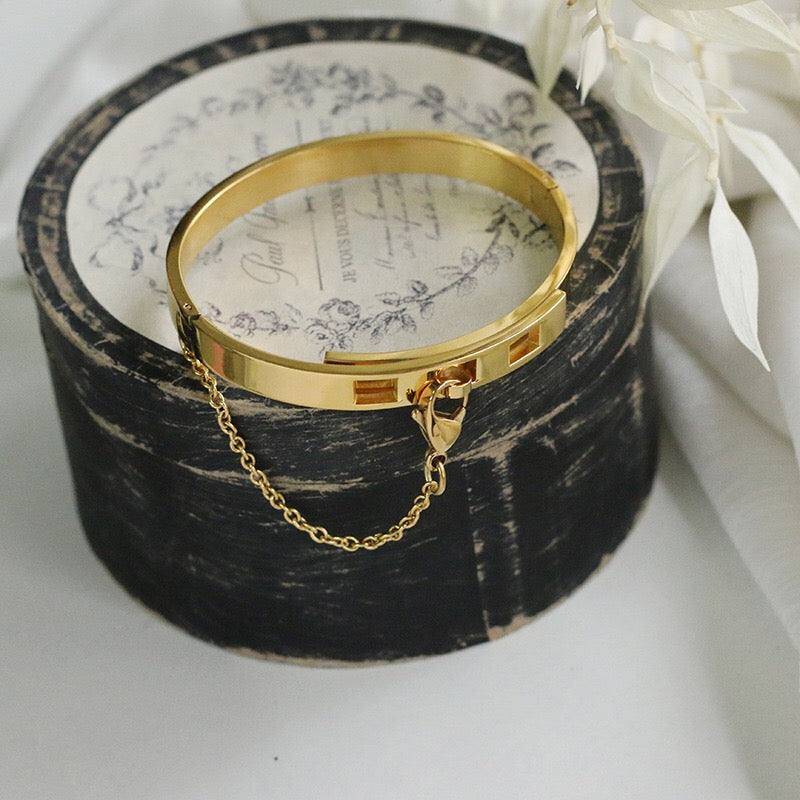 Thin Gold Color Plated Cuff Bracelet with Chain Closure is a thin sized Bracelet that has our signature chained hook closure